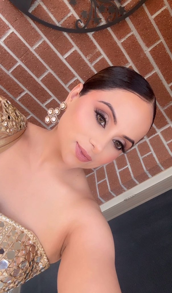 Soft glamorous makeup with a sleek hairstyle and gold outfit